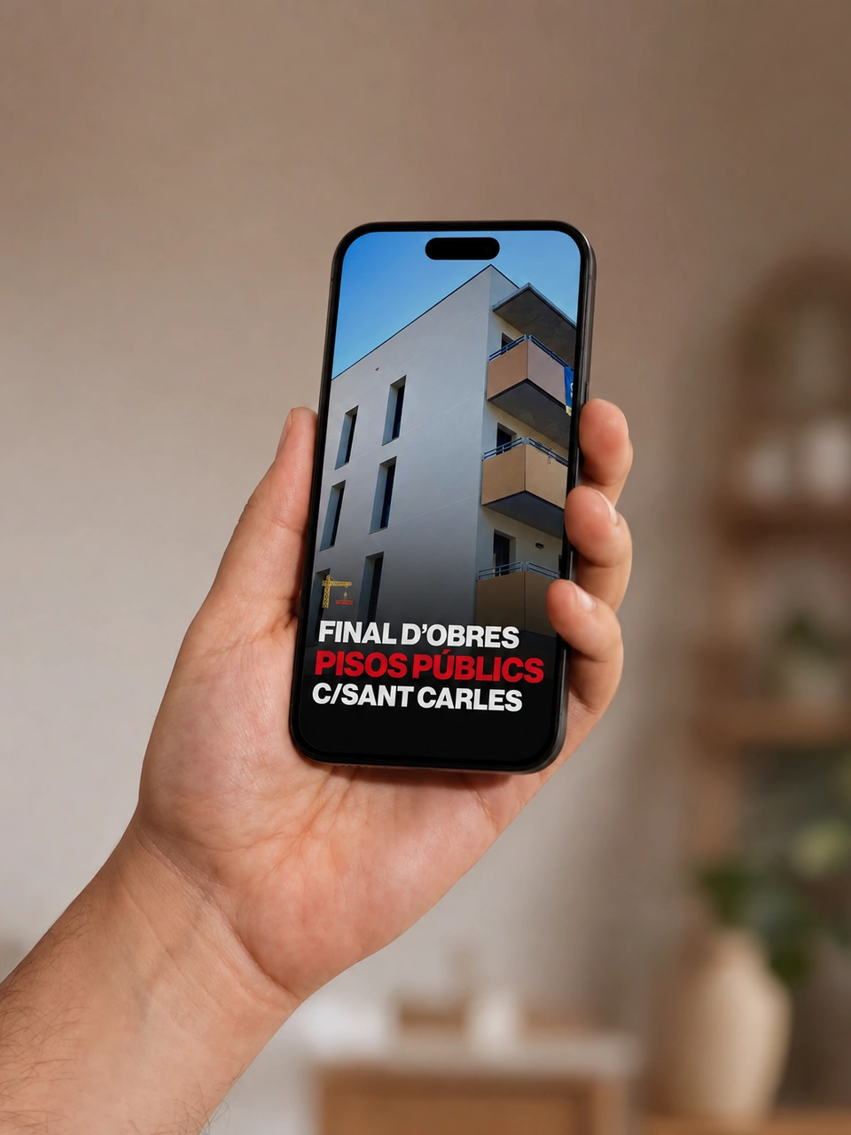 Hand holding an iPhone displaying the Sempre Igualada public housing graphic.